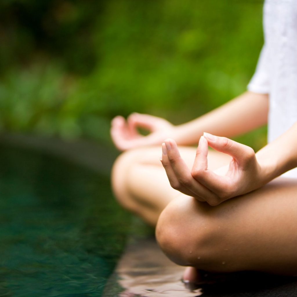 lady meditating outdoors to connect with the power of pause as she navigates post-election emotions