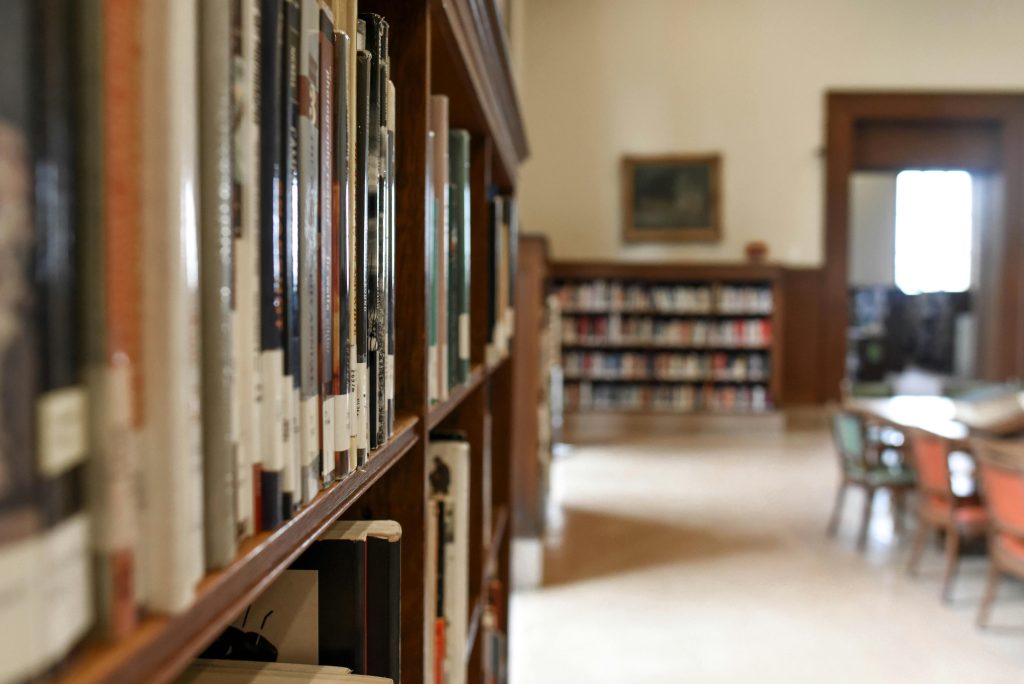 a library stack of shelves, tables and chairs the perfect setting to meet with your coach!
